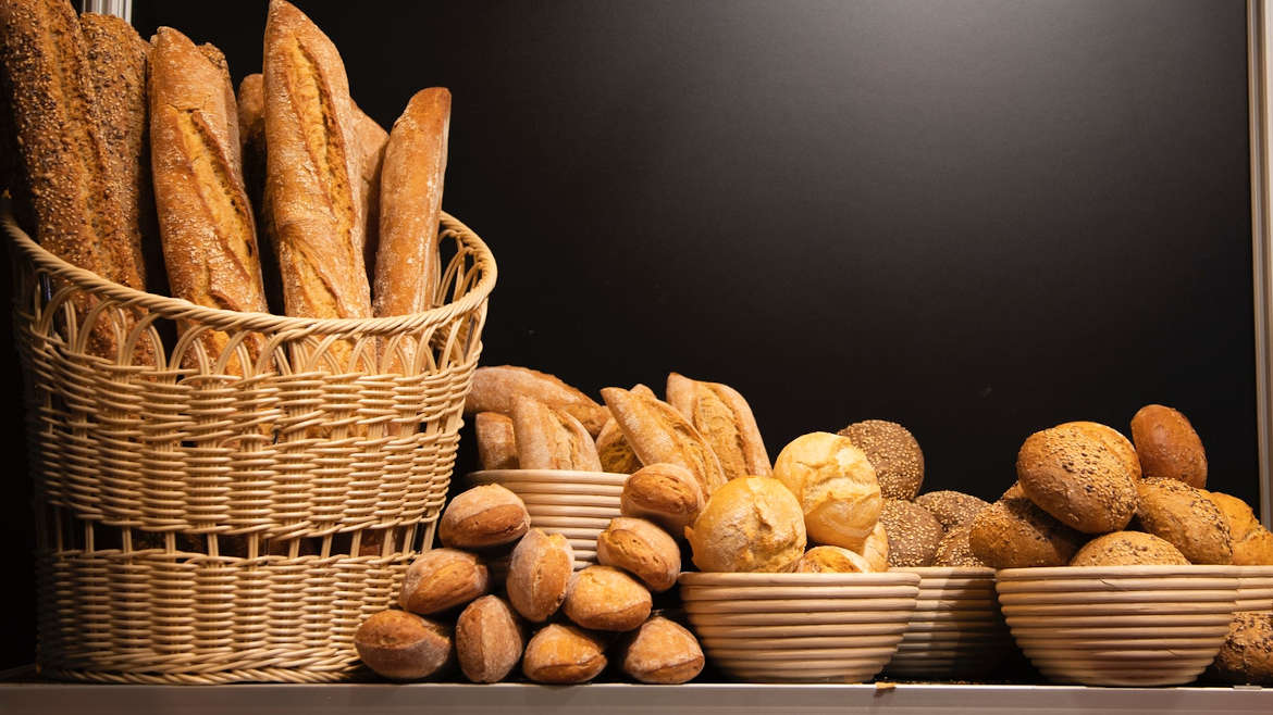 Assortment of bread loves in baskets and bowls