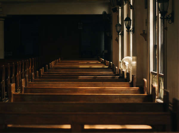 Golden light filtering into a church worship space