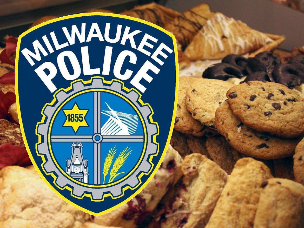 Milwaukee Police badge in front of platters of assorted cookies