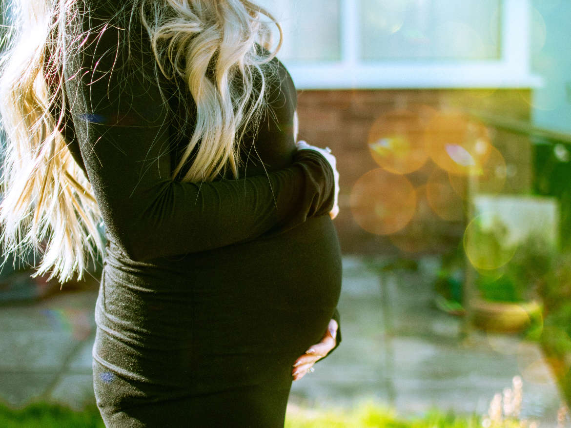 Pregnant women holding her stomach