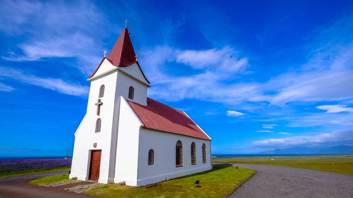 Small white church on green grass